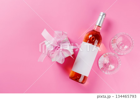 Gift box and wine glasses on pink background 134465793