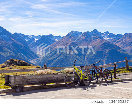 Scuol, Switzerland - October 11th 2025: Two bikes in front of the impressive view from motta naluns biking resort Scuol, Switzerland - October 11th 2025: Two bikes in front of the impressive view from motta naluns biking resort 134465827