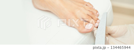 Female receiving pedicure at spa with focus on foot care and nail polish 134465944