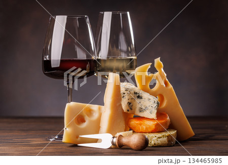 Assorted cheeses paired with glasses of wine on a rustic table Assorted cheeses paired with glasses of wine on a rustic table 134465985