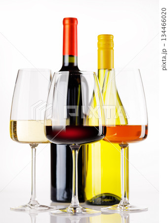 Different wine bottles and glasses on white background 134466020