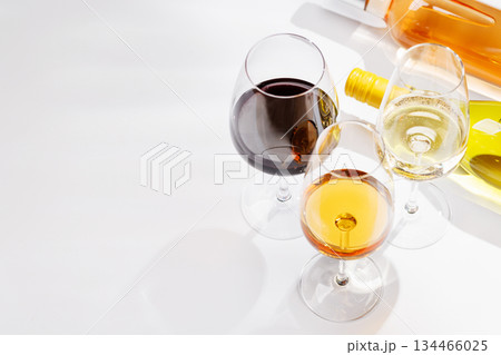 Different wine bottles and glasses on white background Different wine bottles and glasses on white background 134466025