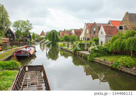 Dutch village with houses by canal 134466111