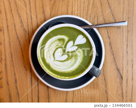 Matcha latte with heart pattern viewed from above. Minimalism, calm energy and Japanese-inspired cafe ritual. Matcha latte with heart pattern viewed from above. Minimalism, calm energy and Japanese-inspired cafe ritual. 134466501