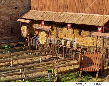 Medieval archery range beside fortress wall. Recreation, historical heritage and outdoor sporting tradition. Medieval archery range beside fortress wall. Recreation, historical heritage and outdoor sporting tradition. 134466535