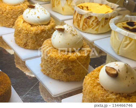 Assorted cakes and desserts in pastry display. Sweetness, craftsmanship, and indulgence in modern patisserie presentation. Assorted cakes and desserts in pastry display. Sweetness, craftsmanship, and indulgence in modern patisserie presentation. 134466746