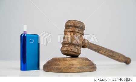Judge's gavel and electronic cigarette. Smoking ban. Tobacco heating systems. Judge's gavel and electronic cigarette. Smoking ban. Tobacco heating systems. 134466820