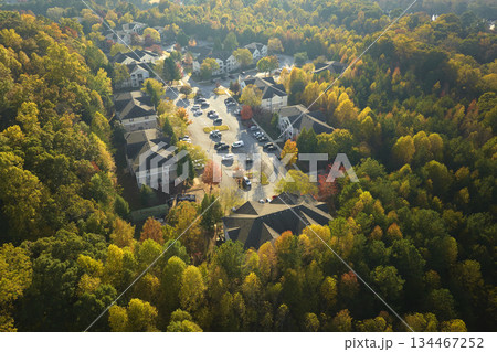 Aerial view of new apartment houses between yellow trees in South Carolina suburban area in fall season. Real estate development in american suburbs 134467252