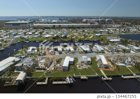 Aerial view of natural disaster consequences in Florida Southwest region. Severely damaged by hurricane Ian mobile homes in residential area Aerial view of natural disaster consequences in Florida Southwest region. Severely damaged by hurricane Ian mobile homes in residential area 134467255