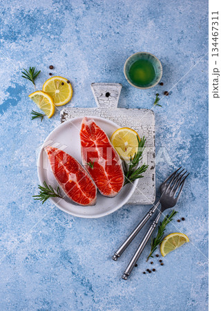 Raw uncooked salmon with rosemary Raw uncooked salmon with rosemary 134467311