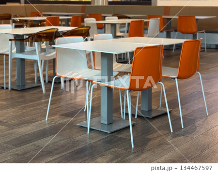 Food court with orange chairs. Modern dining, social life, and public interior. 134467597
