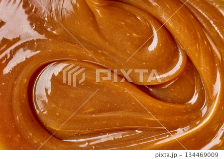 freshly cooked caramel sauce background freshly cooked caramel sauce background 134469009
