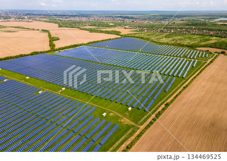 Aerial view of big sustainable electric power plant with many rows of solar photovoltaic panels for producing clean ecological electrical energy. Renewable electricity with zero emission concept. 134469525