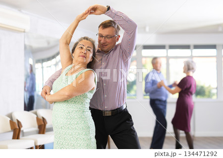 Adult man and elderly woman dance waltz Adult man and elderly woman dance waltz 134471292