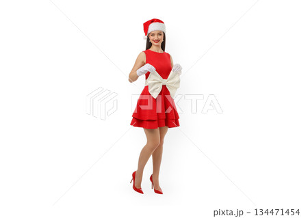 Woman wearing red dress and Santa hat holding large bow, isolated, PNG Woman wearing red dress and Santa hat holding large bow, isolated, PNG 134471454