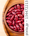 Raw red kidney beans in wooden bowl. Top view 134472213