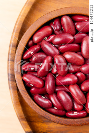 Raw red kidney beans in wooden bowl. Top view Raw red kidney beans in wooden bowl. Top view 134472213