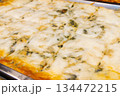 Cheese and spinach lasagne on tray. Close up 134472215