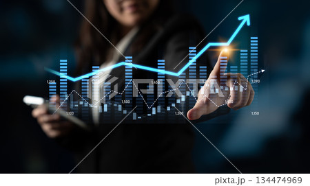 Businesswoman Using Digital Technology to Analyze Growth Trends in Graphs and Data Visualizations with Abstract Background Scalp Businesswoman Using Digital Technology to Analyze Growth Trends in Graphs and Data Visualizations with Abstract Background Scalp 134474969