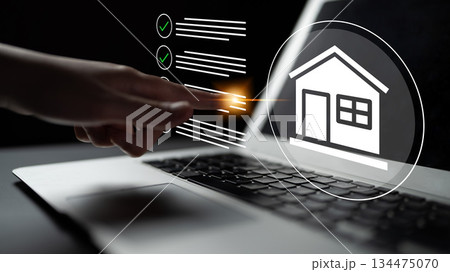 Digital interaction with real estate concept using laptop and hand, showcasing online property management, decision making, and technological advancement in housing Gantry 134475070