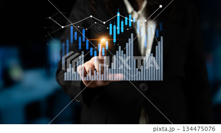 Business professional analyzing financial data on a digital screen with graphs and charts showcasing trends and market performance for investment analysis Scalp 134475076