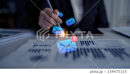 Digital Communication Concept, Virtual Email Messaging, Business Analysis with Graphs, Creative Technology Integration, Hand with Pen, Modern Workspace Gantry 134475133