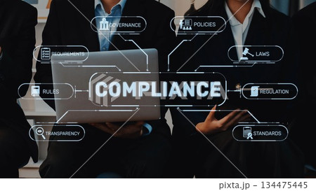 Business professionals discussing compliance concepts with laptop and infographic showing requirements, rules, regulations, policies, and governance strategies. Raster 134475445