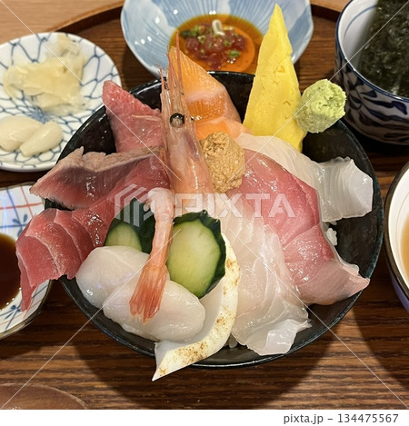 Fresh and delicate sashimi slices, beautifully presented with vibrant colors and perfect cuts. This traditional Japanese delicacy highlights the pure flavors of premium seafood. 134475567
