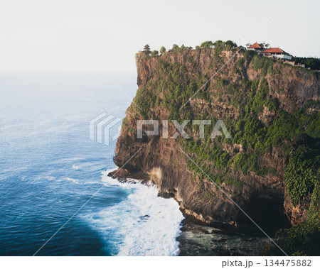 Ancient Uluwatu Temple Aerial view - iconic landmark and popular Bali tourist attraction. Uluwatu cultural heritage and breathtaking panoramic seascapes in Indonesia Bali exotic tropical settings 134475882