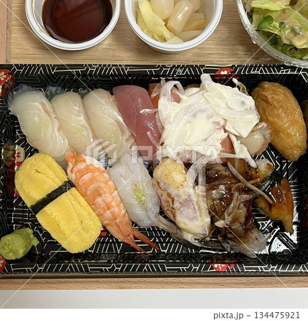 An assortment of fresh sushi, artfully arranged with a variety of toppings and vibrant colors. This traditional Japanese dish combines vinegared rice, seafood, and vegetables for an experience. 134475921