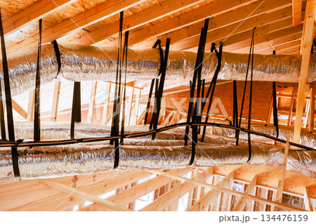 Workers install ductwork in new building under construction Workers install ductwork in new building under construction 134476159
