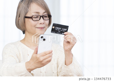 スマホ決済をするシニア女性 134476733