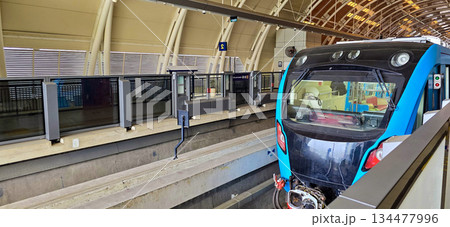 Light Rail Transit or LRT or rail transport system in Indonesia, modern metro train stationed at an urban platform, showcasing efficient public transport Light Rail Transit or LRT or rail transport system in Indonesia, modern metro train stationed at an urban platform, showcasing efficient public transport 134477996