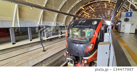 Light Rail Transit or LRT or rail transport system in Indonesia, modern metro train stationed at an urban platform, showcasing efficient public transport Light Rail Transit or LRT or rail transport system in Indonesia, modern metro train stationed at an urban platform, showcasing efficient public transport 134477997