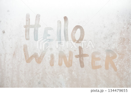 Holiday winter greeting with text hello winter. New Year's eve concept. Holiday winter greeting with text hello winter. New Year's eve concept. 134479655
