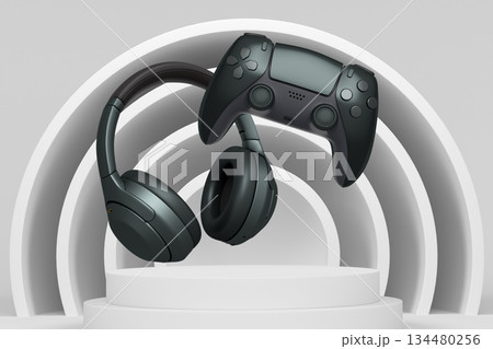 Wireless gaming controller and headphones displayed over podium on abstract background, concept of modern gaming technology Wireless gaming controller and headphones displayed over podium on abstract background, concept of modern gaming technology 134480256