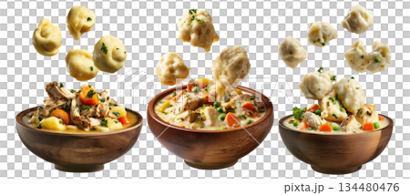 Hearty chicken and dumplings soup with peas and carrots in wooden bowl, floating dumplings, isolated on white background 134480476