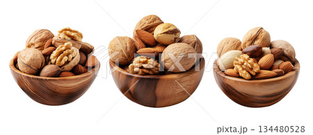 Assorted walnuts and almonds in natural wood bowl with some nuts floating above, isolated on white background Assorted walnuts and almonds in natural wood bowl with some nuts floating above, isolated on white background 134480528