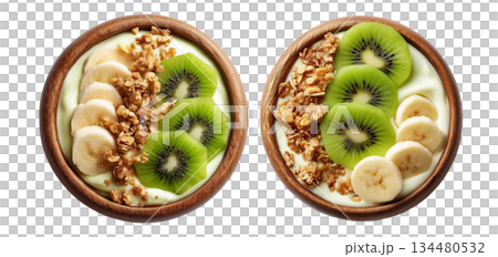 Wooden bowl filled with yogurt or smoothie, sliced kiwi, banana, granola, chia seeds, and fresh mint leaves 134480532