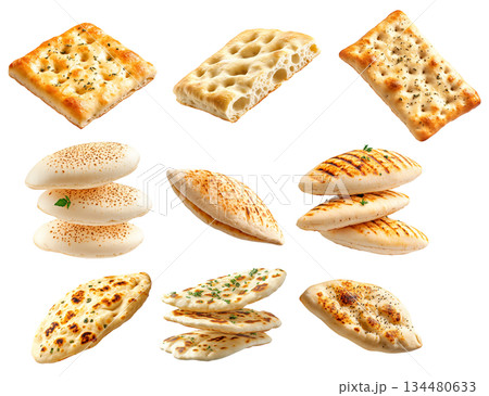 Various types of flatbreads and pita breads arranged on white background, showing texture and variety, concept of traditional food 134480633