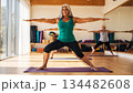 Smiling senior Hispanic woman practicing Pilates in a gym. Concept of physical activity for older adults and active aging 134482608