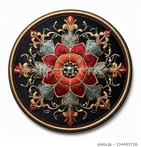 Intricate Floral Embroidery Ornament Featuring Red Blossoms and Golden Accents on Dark Textured Circular 134483726