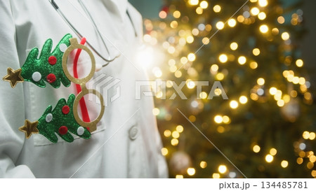 Ophthalmologist Doctor Wishes His Patients a Merry Christmas in Front of Tree Ophthalmologist Doctor Wishes His Patients a Merry Christmas in Front of Tree 134485781
