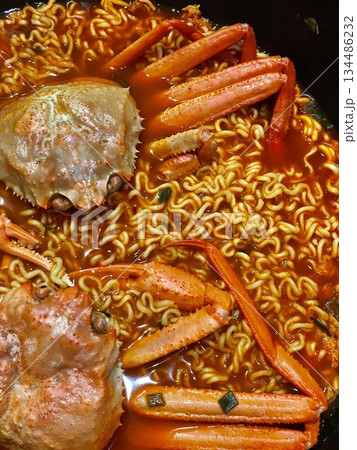 Kkotgae Ramyeon, a spicy crab ramen dish with rich seafood broth, tender noodles, and fresh vegetables. A hearty and flavorful Korean comfort food. 134486232