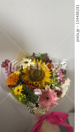 Bouquet of fresh flowers with vibrant colorful petals and lush green leaves, carefully arranged to highlight natural beauty, soft textures, and harmonious elegance in close-up detail Bouquet of fresh flowers with vibrant colorful petals and lush green leaves, carefully arranged to highlight natural beauty, soft textures, and harmonious elegance in close-up detail 134486281