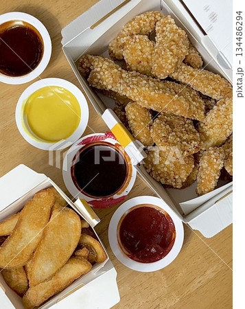 Crispy Korean fried chicken, perfectly glazed with a sweet and spicy sauce. Ideal for food photography and menus, showcasing the irresistible crunch and flavor of this beloved dish. 134486294