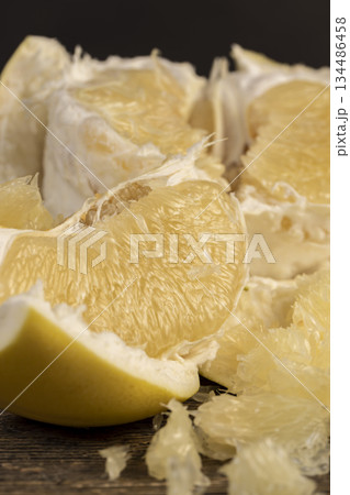 soft flesh of ripe grapefruit, sweet fresh grapefruit peeled from the yellow thick peel soft flesh of ripe grapefruit, sweet fresh grapefruit peeled from the yellow thick peel 134486458