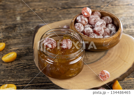 jam made from oranges and fresh citrus fruits and dried in sugar syrup, whole kumquat fruits in white powder jam made from oranges and fresh citrus fruits and dried in sugar syrup, whole kumquat fruits in white powder 134486465