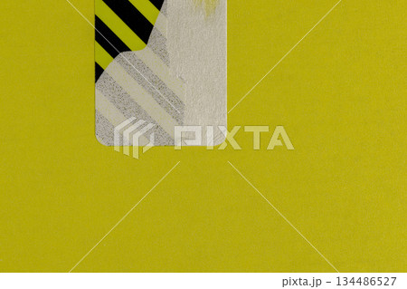 an open yellow package with a torn protective sticker against theft, a torn striped sticker to protect the goods from opening, indicating that the box was opened an open yellow package with a torn protective sticker against theft, a torn striped sticker to protect the goods from opening, indicating that the box was opened 134486527