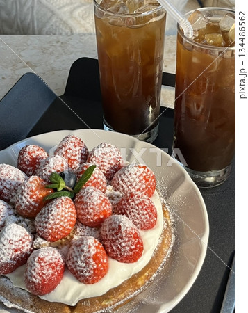 Crispy, golden waffles topped with creamy ice cream, creating a perfect balance of warm and cold, crunchy and smooth. A delightful dessert or breakfast treat, with toppings like fruits or syrup. 134486562